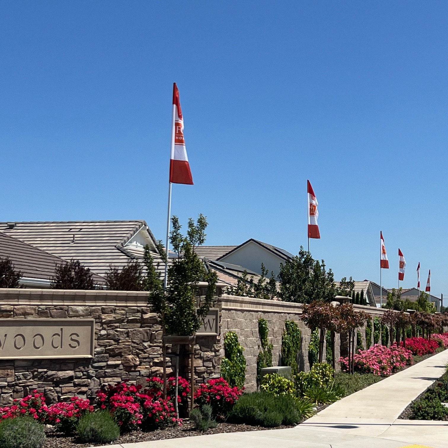 Commercial flag display at a landscaped residential entrance