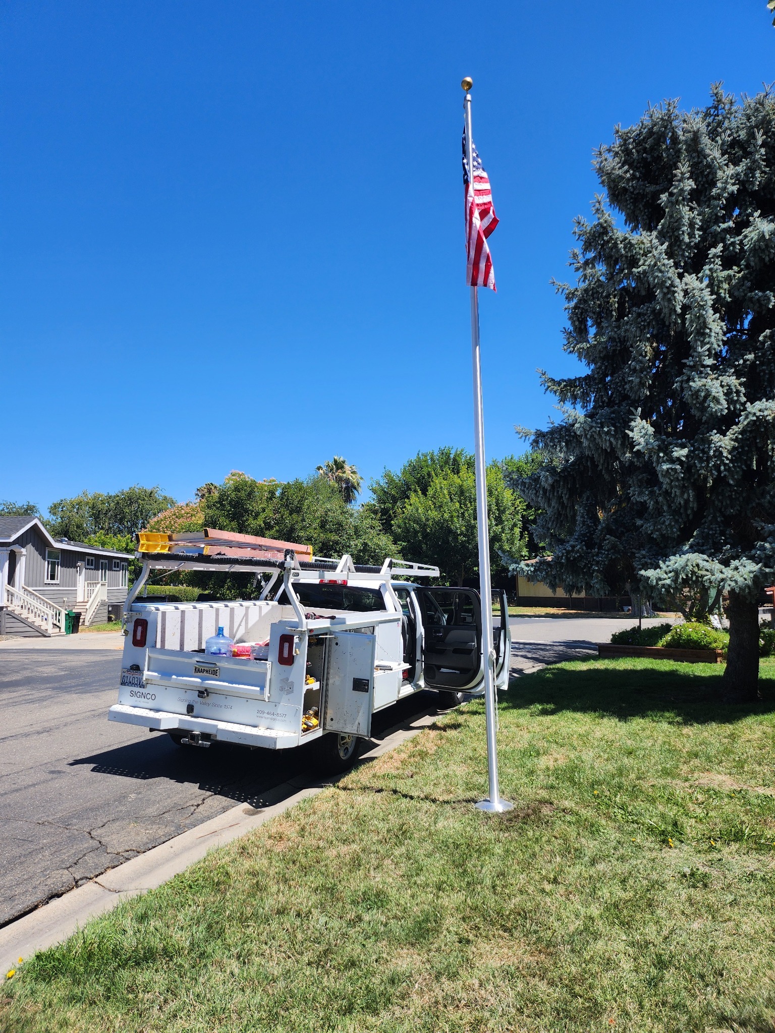 Installed flagpole in a landscaped public setting